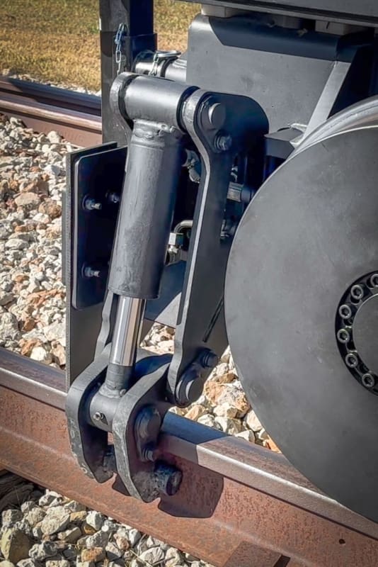 Close up image of rail clamps on DymaxRail excavator attachment