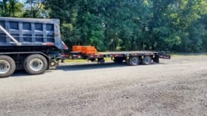 Truck pulling a tag along hi rail trailer built by DymaxRail