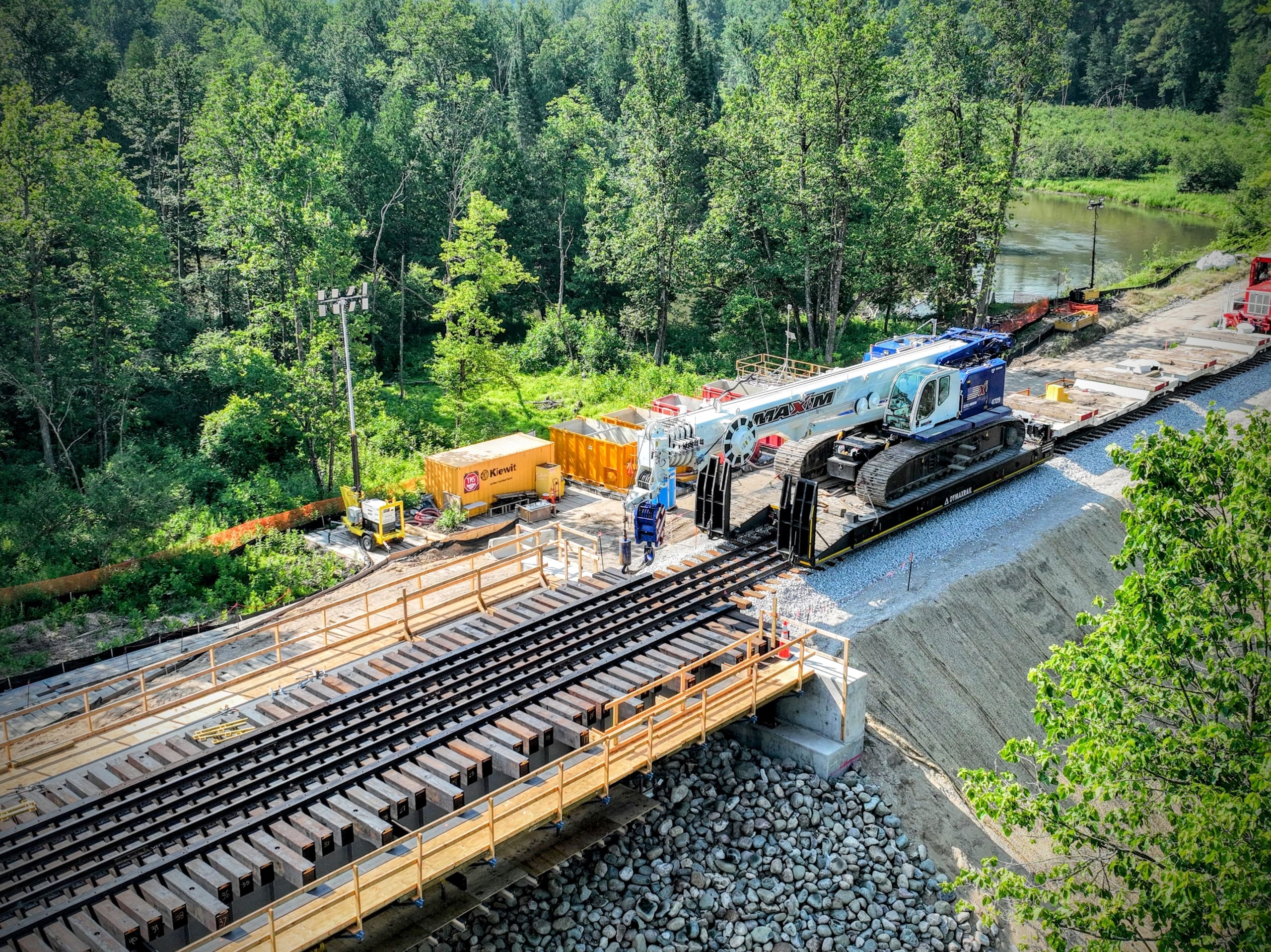 Crawler crane delivered to the bridge replacement site using rail-based equipment transport.