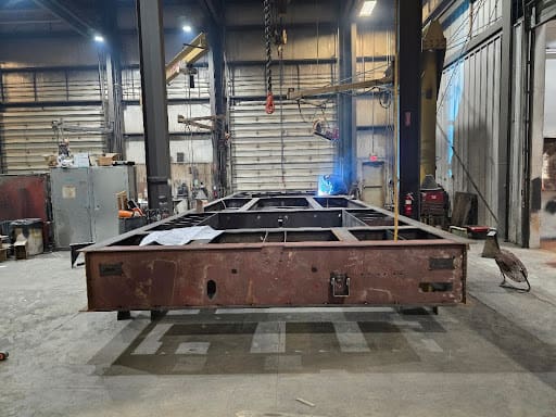 DymaxRail 100-ton Machinery Cart steel frame during fabrication in Kansas.